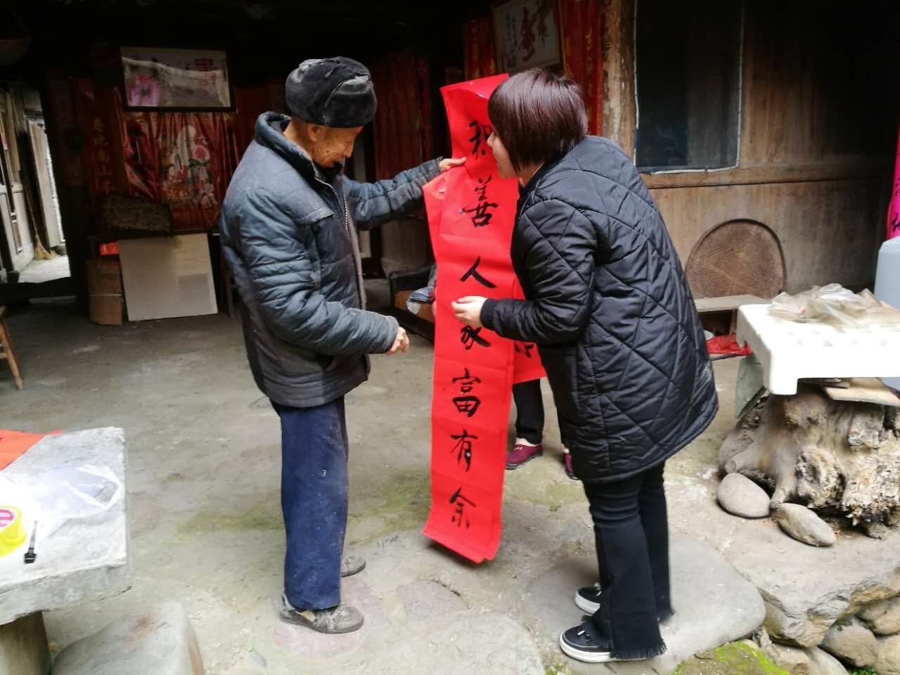 圖為毛垟鄉(xiāng)毛垟村的村民正喜滋滋地將剛得到的“廉潔春聯(lián)”拿回家張貼，讓該村的春節(jié)有了濃濃的“廉”味。.jpg